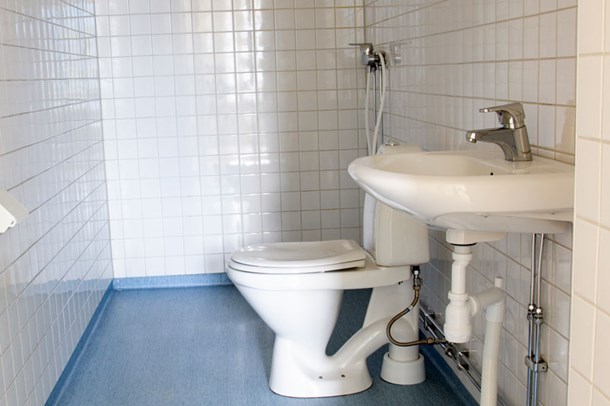 An example of a bathroom, this one has white walls and a blue floor.