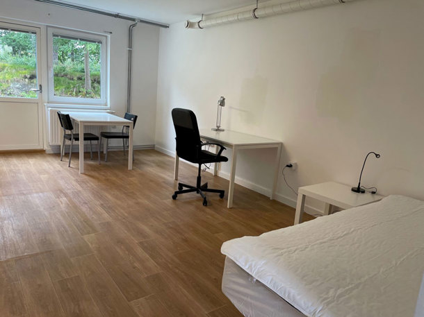Room with bed, chairs and tables